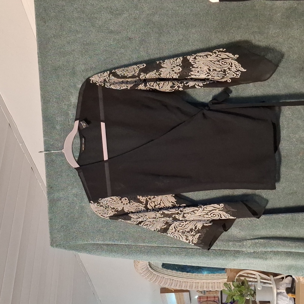 Black Wrap Top with White Design On The Sleeves.